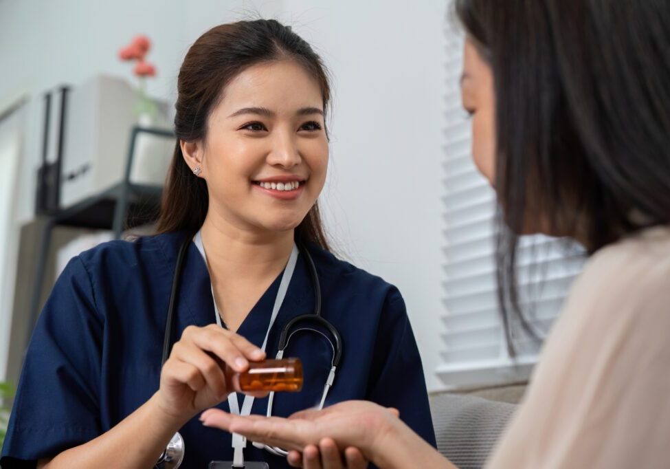 Nurse giving medication to a patient.